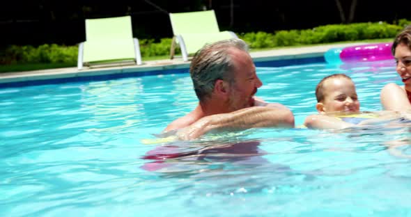 Family enjoying in swimming pool