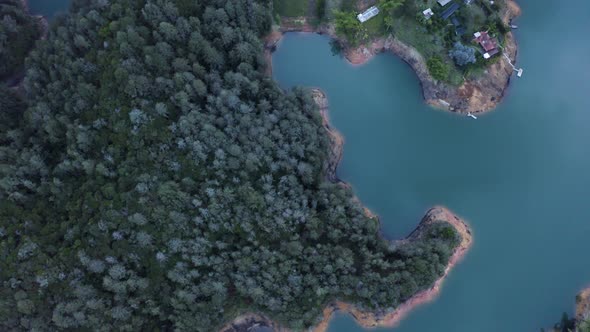 Aerial shot of a Lake at guatape, tilting up into the landscape. Colombia.