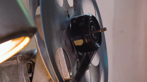 Large Spool with Film Reel Rotates By Old Cinema Equipment