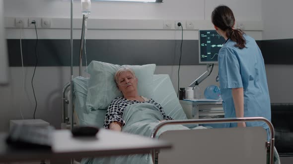 Aged Patient with Illness Resting in Hospital Ward Bed