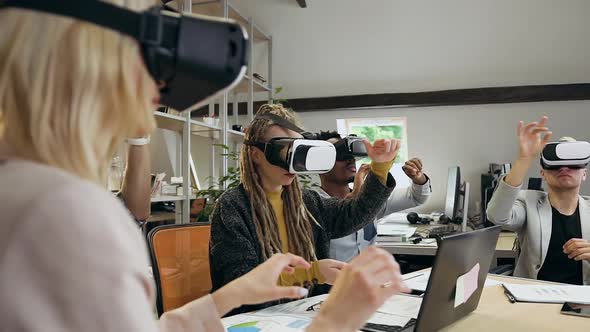 Creative Diverse Team of Office Coworkers which Working Under Joint Project Using Virtual Reality