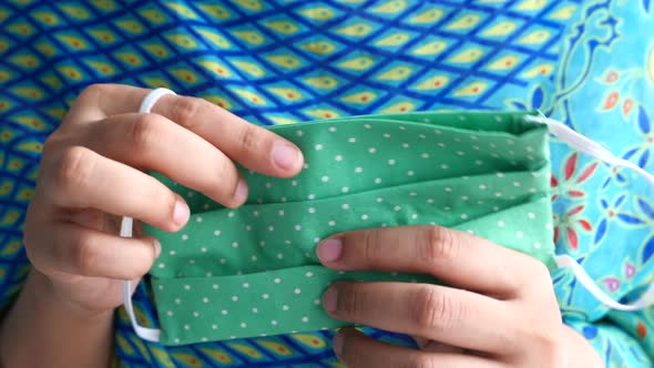 Women Hand Holding Homemade Face Mask, Close Up 