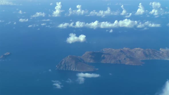 Aerial footage. Airliner flies over the Greek Island of Tilos, Aegean Sea.