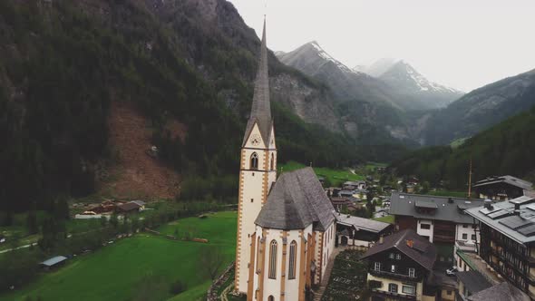 Nostalgic church in a green valley surrounded by the Austrian alps.