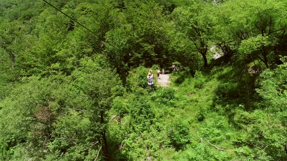 Aerial view of person zip-lining in Soca valley, Slovenia.