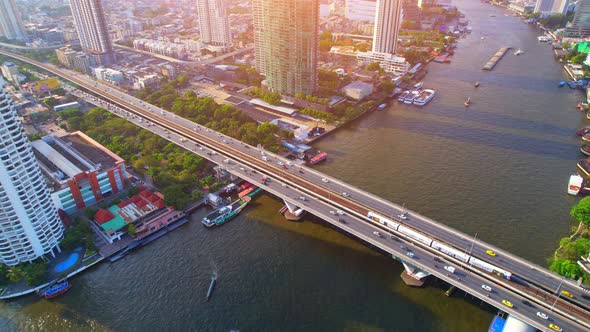 4K : Drones fly over the Chao Phraya River. Aerial view over bts skytrain