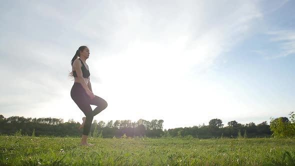 Concept of Health, Stretching and Healthy Lifestyle. Young Female Athlete Sitting on an Exercising