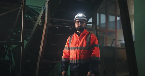 Man Standing Under Conveyor Belt