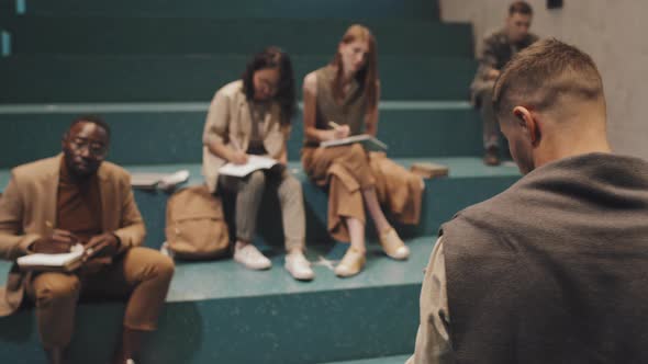 University Students Having Lesson on Stairs Indoors