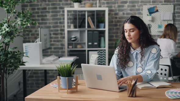 Young Woman Employee Working with Laptop in Office Doing Work in Internet