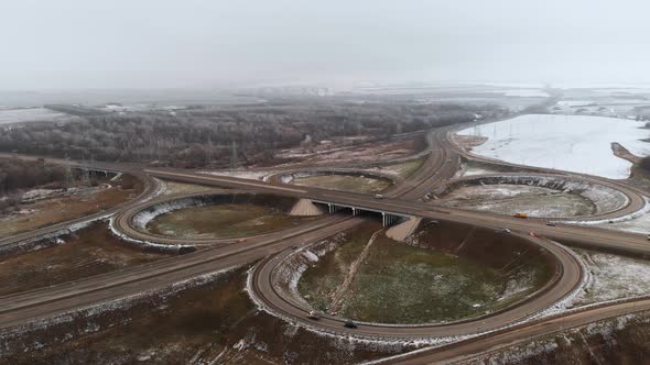 Aerial shot of cars and trucks moving at a winter intersection is a big road junction.