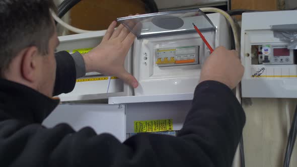 Electrician fixing fuses