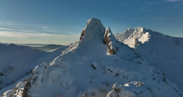 Fly Over and Around the Mountains of Ciucas Romania in January 2022 Sunny Day