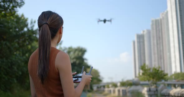 Woman play flying drone at outdoor