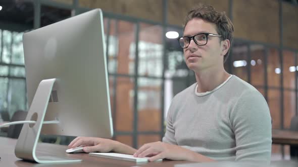 Success Guy Celebrating While Working on Computer