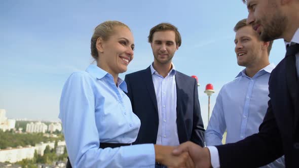 Business Woman and Man Shaking Hands, Work Partners Applauding Celebrating Deal