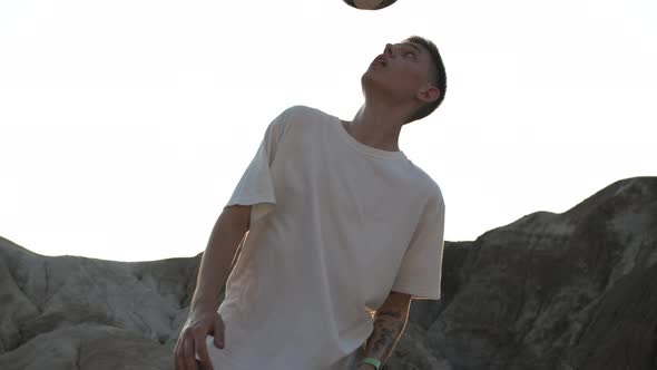 Young Man Professionally Performs Various Tricks with a Soccer Ball