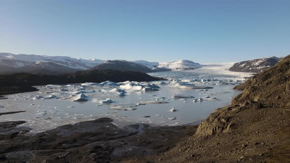 Drone Towards Landscape Towards Lake Of Ice Formations And Glacier