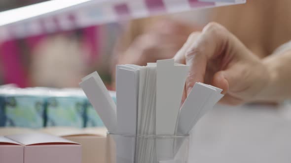 Female Hands Taking Perfume Blotter