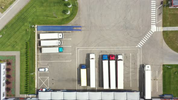 Aerial view. goods distribution warehouse. Semi trucks loading cargo containers. Logistics export an