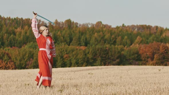 Feisty Woman in Red Dress Rotating Her Swords on the Field