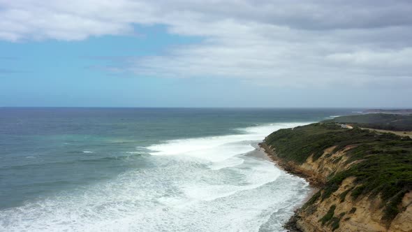 AERIAL White Waves Roll Into The Coastline Of Bells Beach, Australia