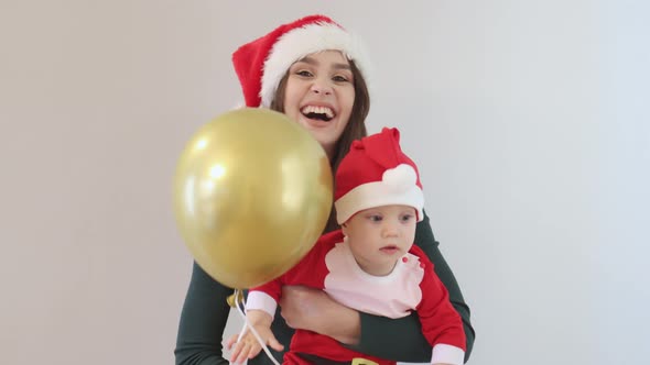 Happy Caucasian Christmas Family Mother Green Shirt Baby Santa Red Hat Ballon