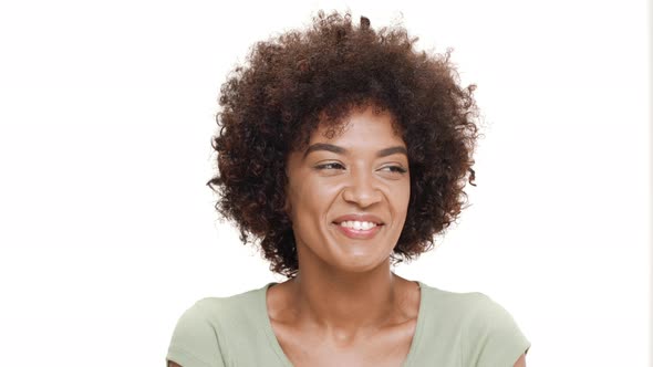 Young Beautiful African Girl Laughing Over White Background