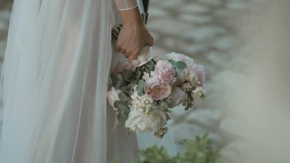 Woman hands with Beautiful pastel White Flower peonies bouquet. Bridal Flower Decoration.