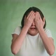 Worried Woman Closes Eyes By Hands with Fear on Green - VideoHive Item for Sale