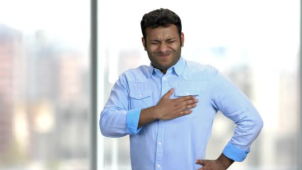 Young Indian Man Having Chest Pain.