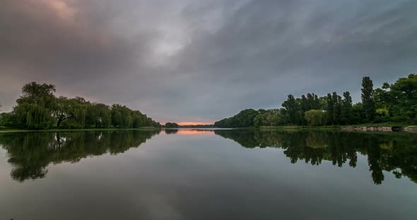 Timelapse of Beautiful Cloudy Sunrise in a Lake with Reflection