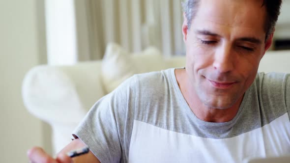 Portrait of smiling man in living room