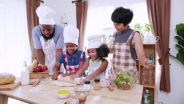 Happy moment of African America family cooking and dancing and song together