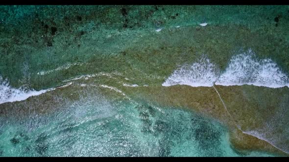 Aerial flying over panorama of perfect coast beach voyage by clear ocean and white sand background o