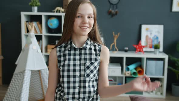 Slow Motion of Cheerful Girl Showing Ok Hand Gesture and Smiling Standing Indoors at Home
