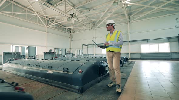 Male Worker Is Observing Indoor Wastewater Reservoirs