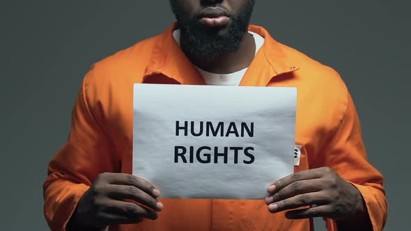 Human Rights Phrase on Cardboard in Hands of African-American Prisoner