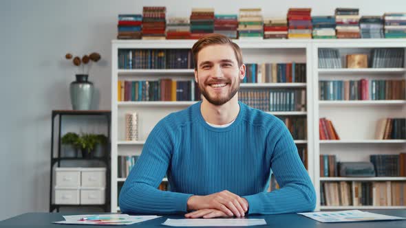 Happy young male smiling, looking to webcam