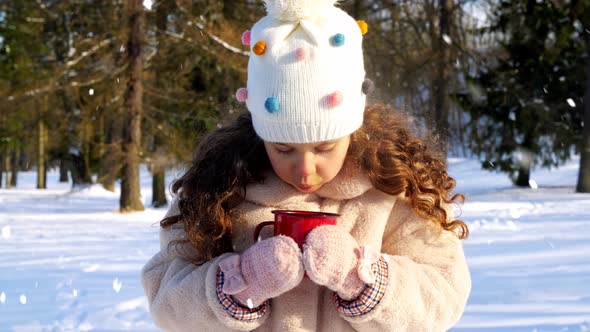 Little Girl with Cup of Hot Tea in Winter Park