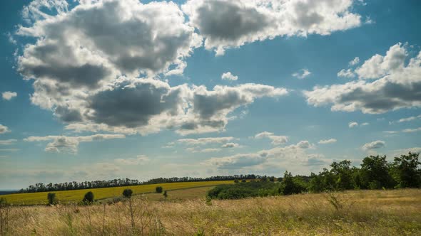 Moving Clouds in Blue Sky Above Landscape Fields. Timelapse. Amazing Rural Valley. Ukraine