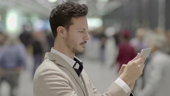 Lifestyle Portrait of Attractive Young Business Man Using Tablet Computer