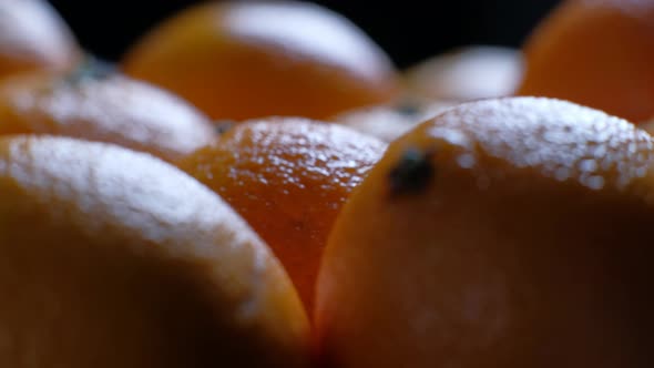 Pile of Unpeeled Round Ripe Orange Mandarin in a Plate