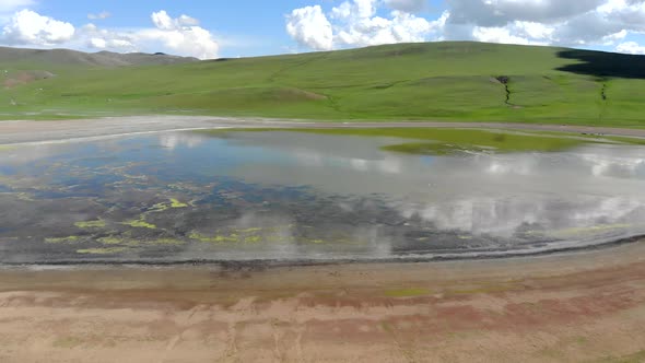 Lake in The Middle of The Treeless Meadow with Aerial View