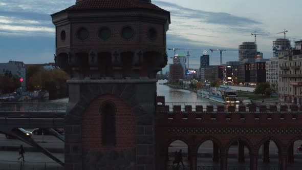 Medium Shot of Oberbaum Bridge Tower in Berlin, Germany Rising Up Revealing Cityscape Skyline with