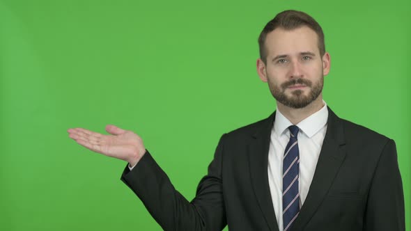 Businessman Holding Something Without Theme Against Chroma Key