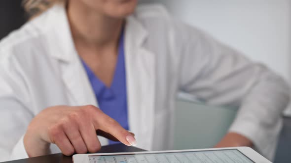 Senior patient completes the questionnaire at  registering to doctor. Shot with RED helium camera in