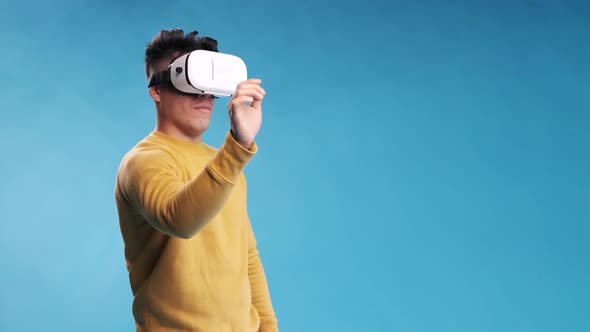 Man touching something in the air while experiencing virtual reality with a VR headset