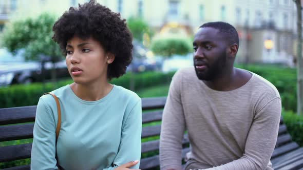 Young Man Talking to Offended Girlfriend on Bench, Jealous Woman, Break Up