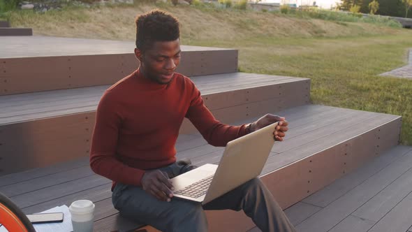 Young African American Business Man Working on Laptop in Park